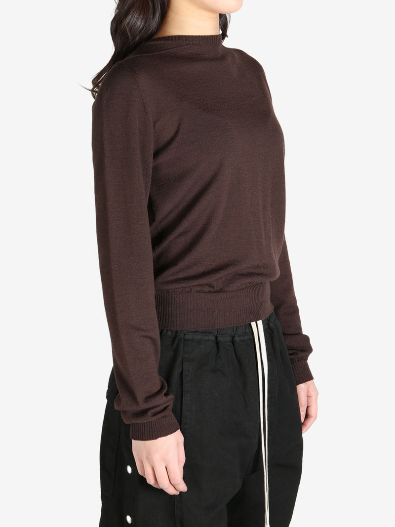 Brown sweater worn by a person, side view