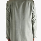 Green jacket worn by a person, showing the jacket's fit