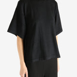 Black t-shirt worn by a person, showing the shirt's fit