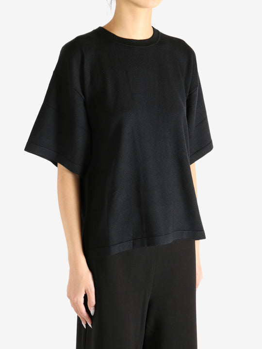 Black t-shirt worn by a person, showing the shirt's fit