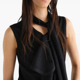 Black top worn by a person, showing the top fit