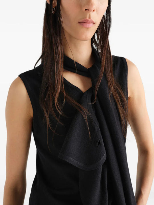 Black top worn by a person, showing the top fit