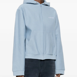 blue hoodie worn by a person, showing the hoodie fit