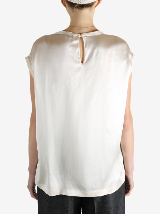 Grey t-shirts worn by a person, showing the t-shirts fit