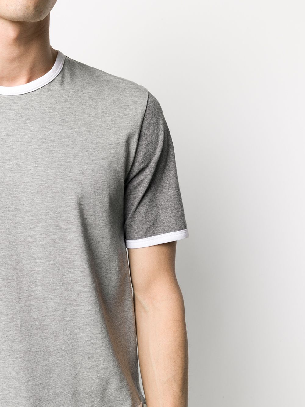 Close up of grey T-shirt, showing texture of the cotton fabric