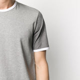 Close up of grey T-shirt, showing texture of the cotton fabric
