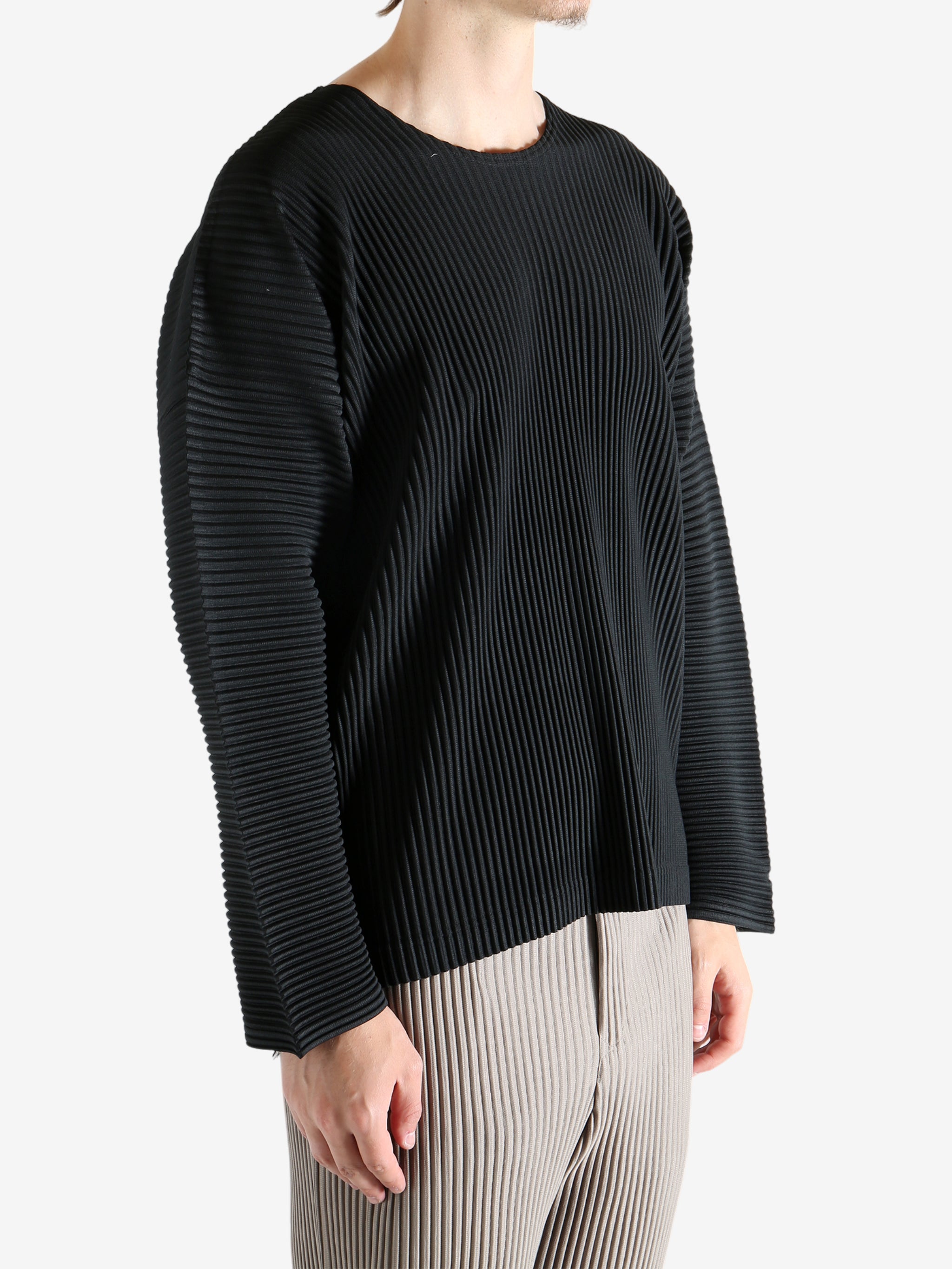 Black t-shirt worn by a person, showing the shirt's fit