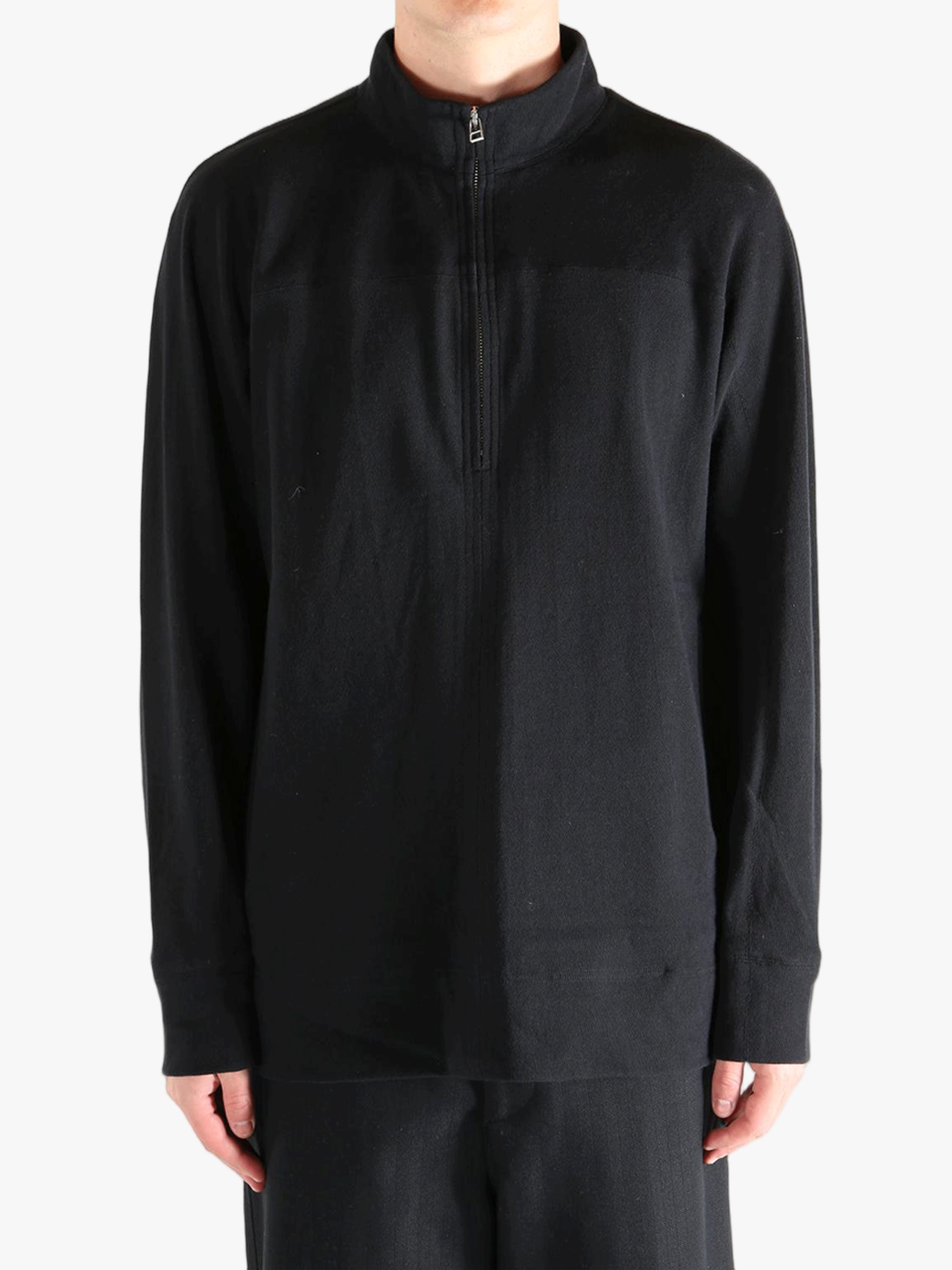 Black jacket worn by a person, showing jacket's fit
