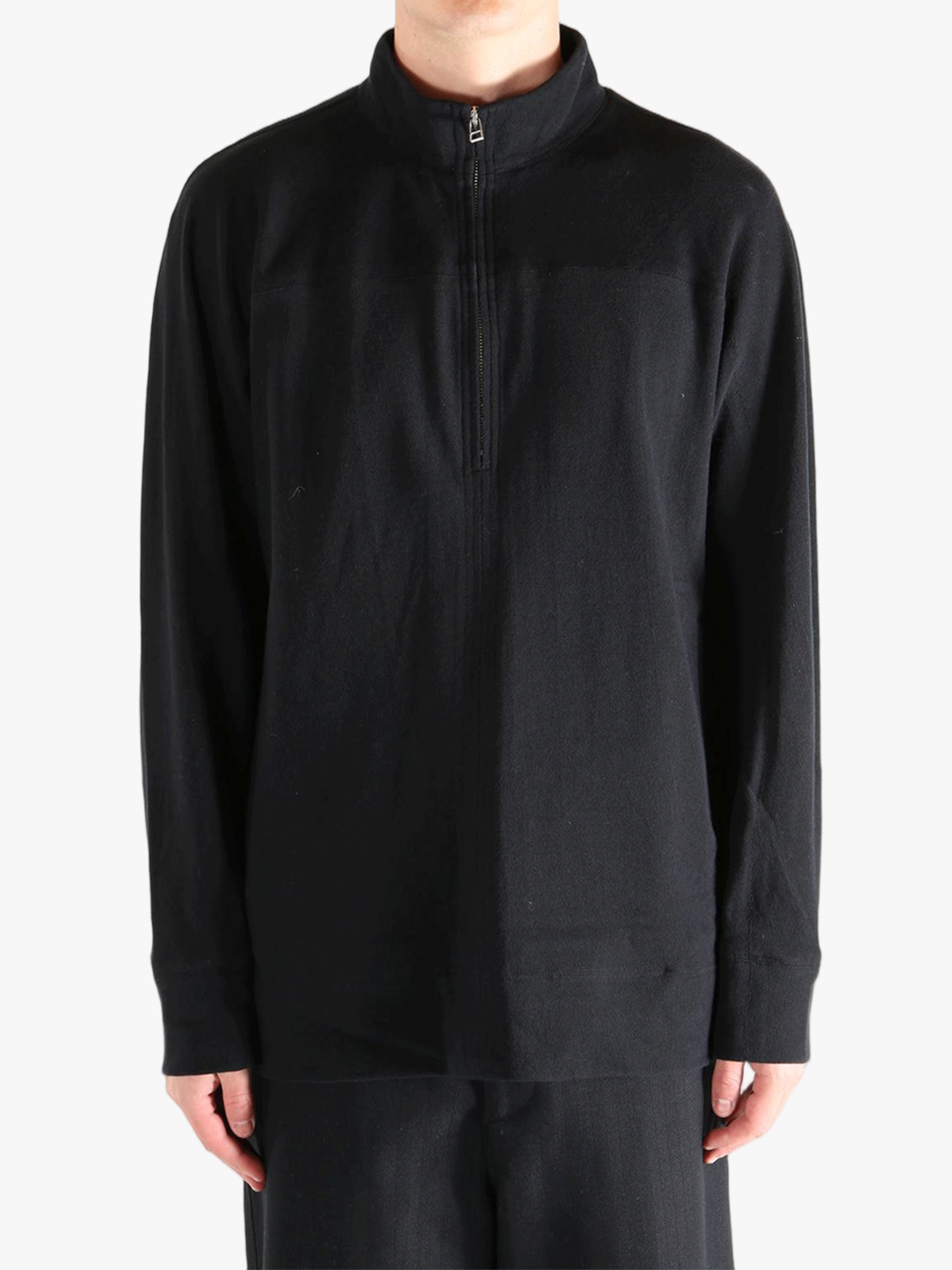 Black jacket worn by a person, showing jacket's fit