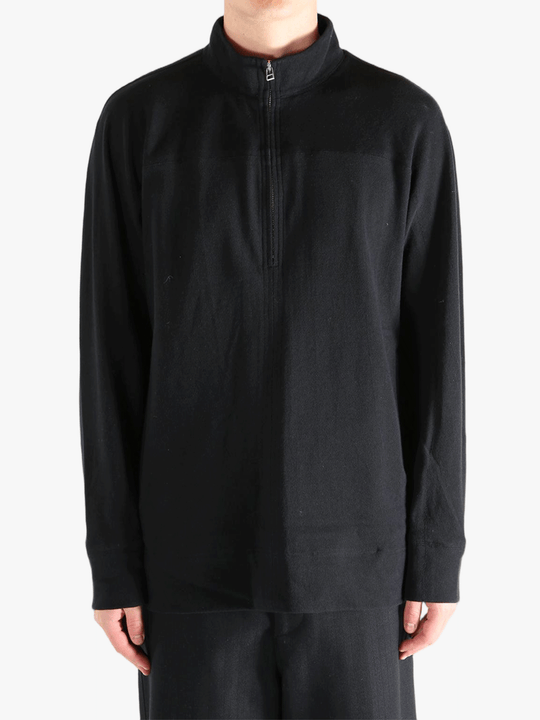 Black jacket worn by a person, showing jacket's fit