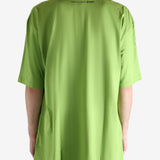 Green t-shirt worn by a person, showing the shirt's fit