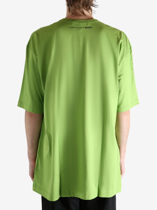 Green t-shirt worn by a person, showing the shirt's fit