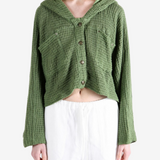 Green knitwear worn by a person, showing the knitwear fit