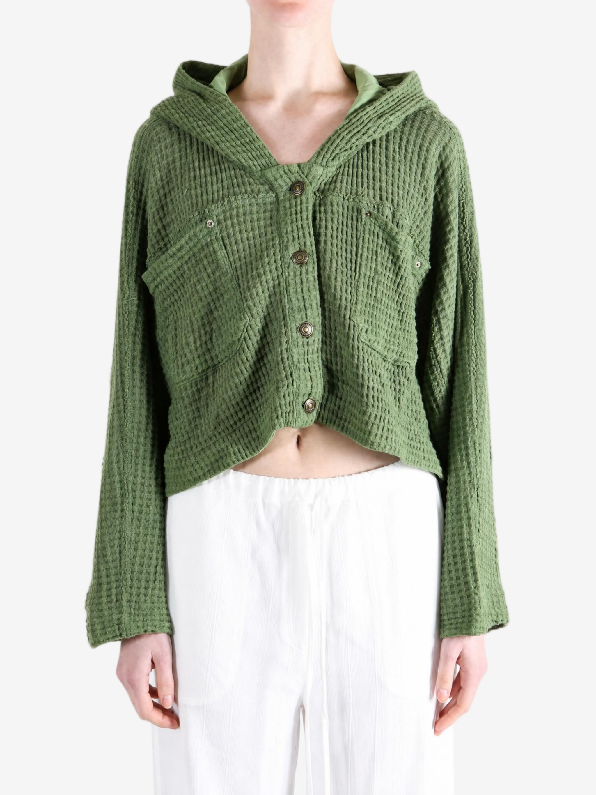 Green knitwear worn by a person, showing the knitwear fit