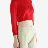 Red cardigan worn by a person, showing the cardigan's fit