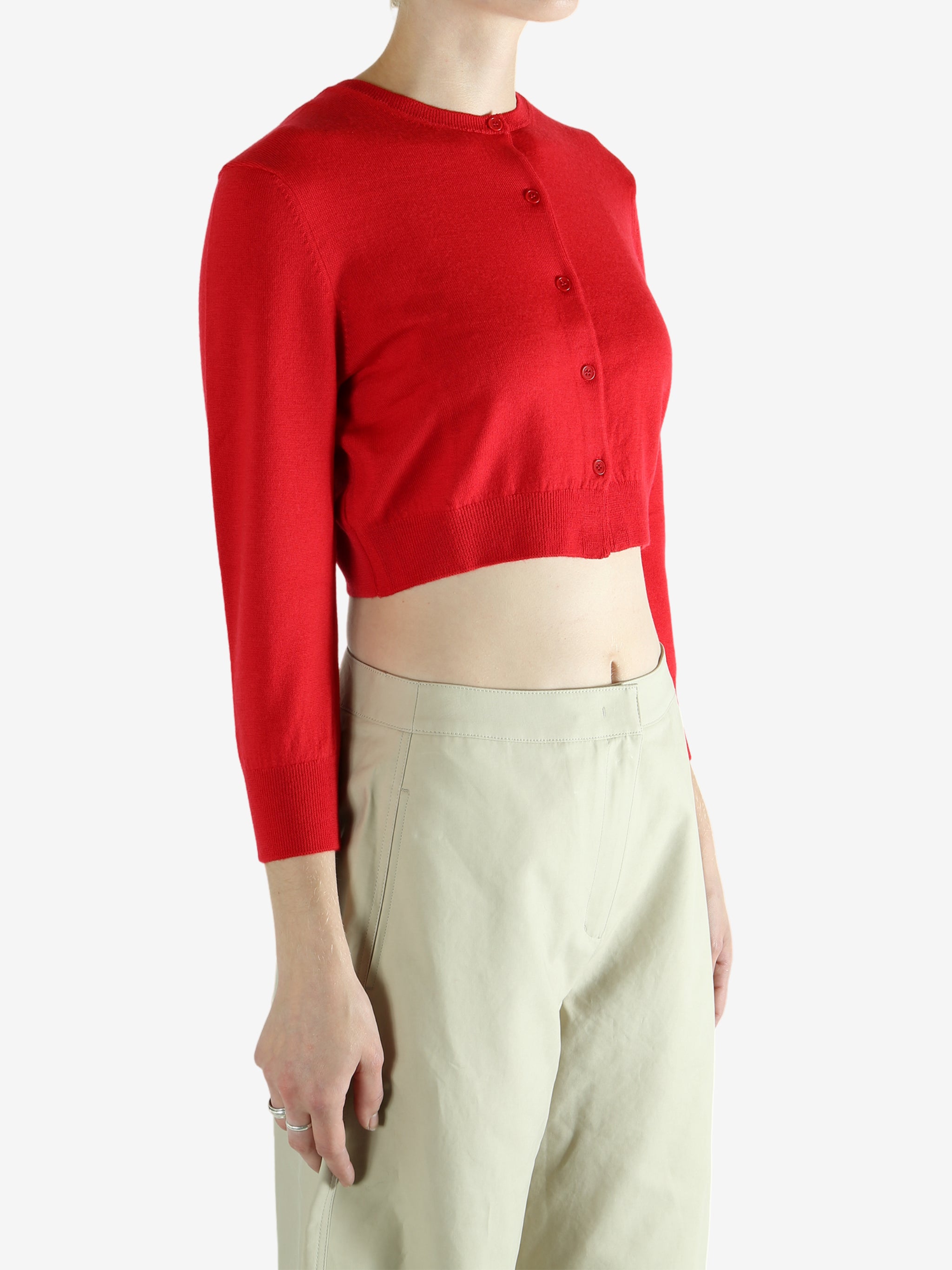 Red cardigan worn by a person, showing the cardigan's fit