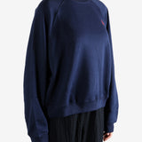 Navy knitwear worn by a person, showing the knitwear fit