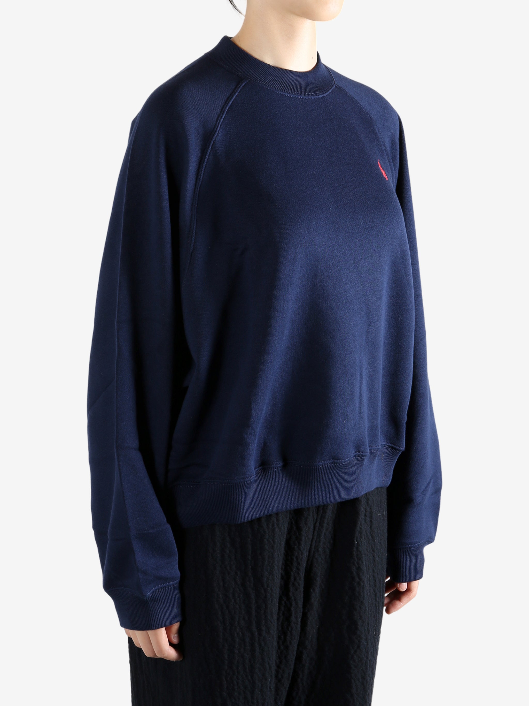 Navy knitwear worn by a person, showing the knitwear fit