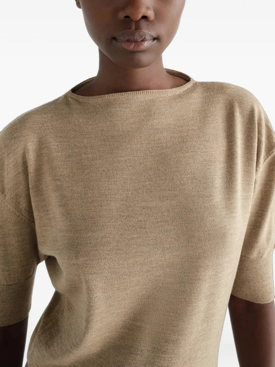 Tan knitwear worn by a person, showing the knitwear fit