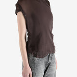 brown top worn by a person, showing the top fit