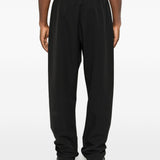 Black pants worn by a person, showing the pants' fit