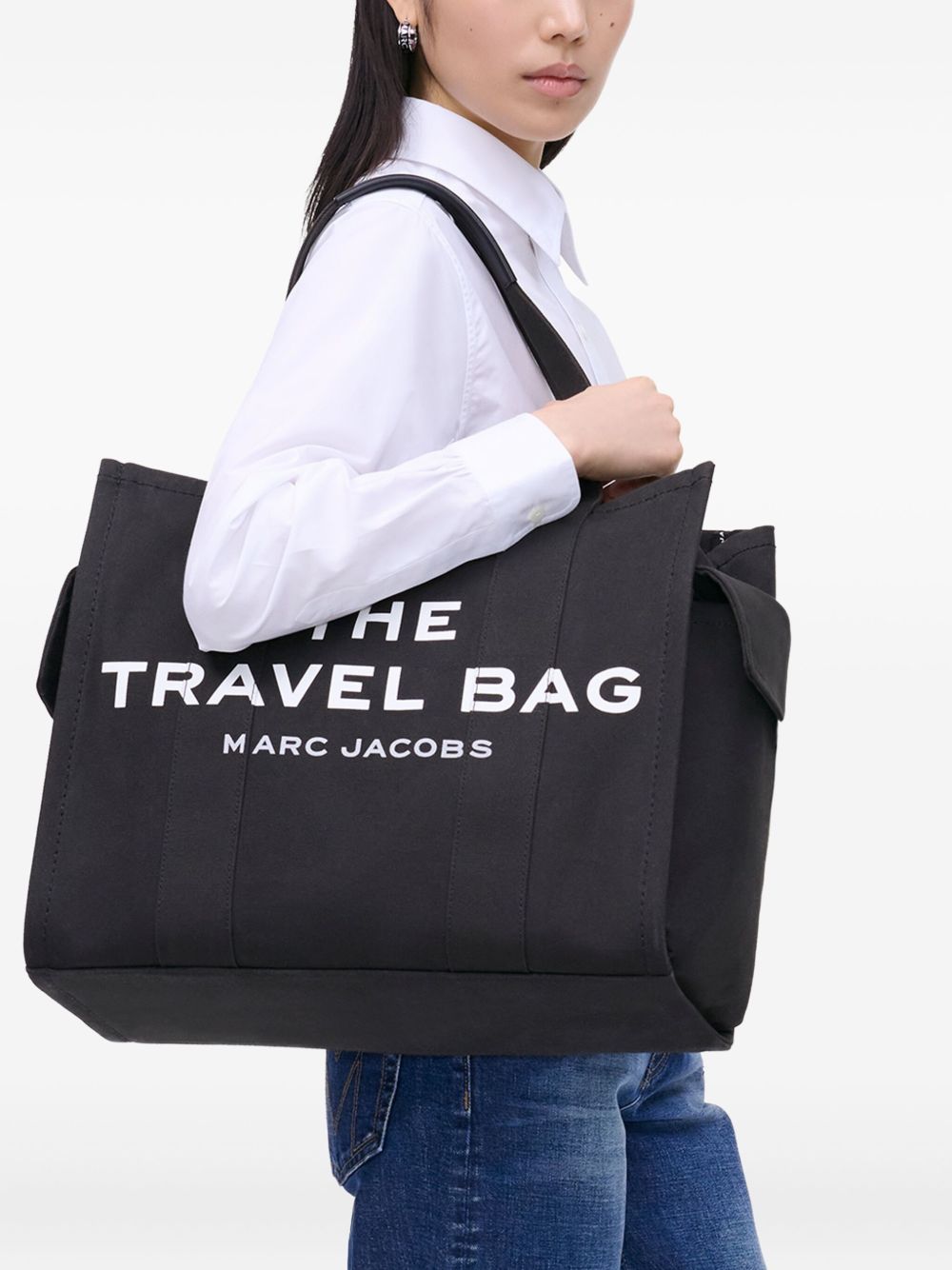 Black bag carried by a person, showing the bag’s fit
