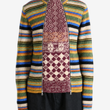 Burgundy knitwear worn by a person, showing the knitwear fit