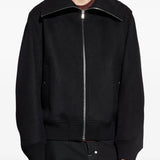 Black jacket worn by a person, showing the jacket's fit