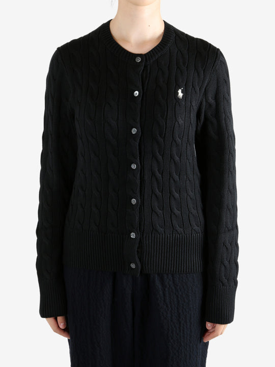 Black knitwear worn by a person, showing the knitwear fit