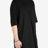 Black shirt worn by a person, showing the shirt's fit