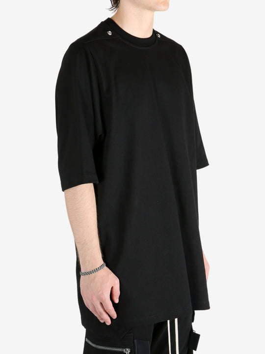 Black shirt worn by a person, showing the shirt's fit