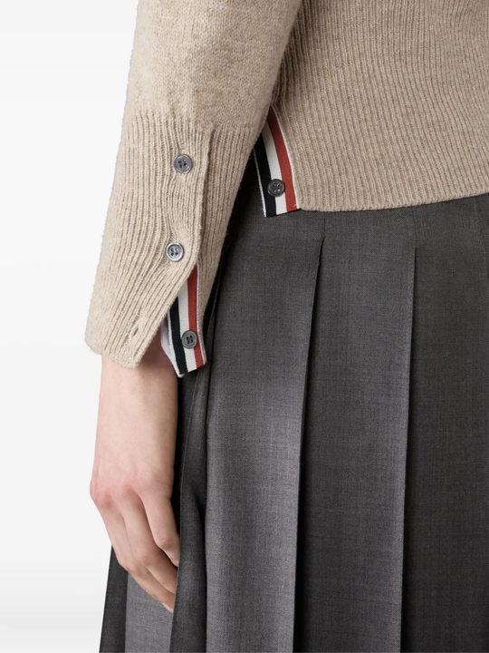 Close up of tan knitwear, showing texture of the Wool fabric