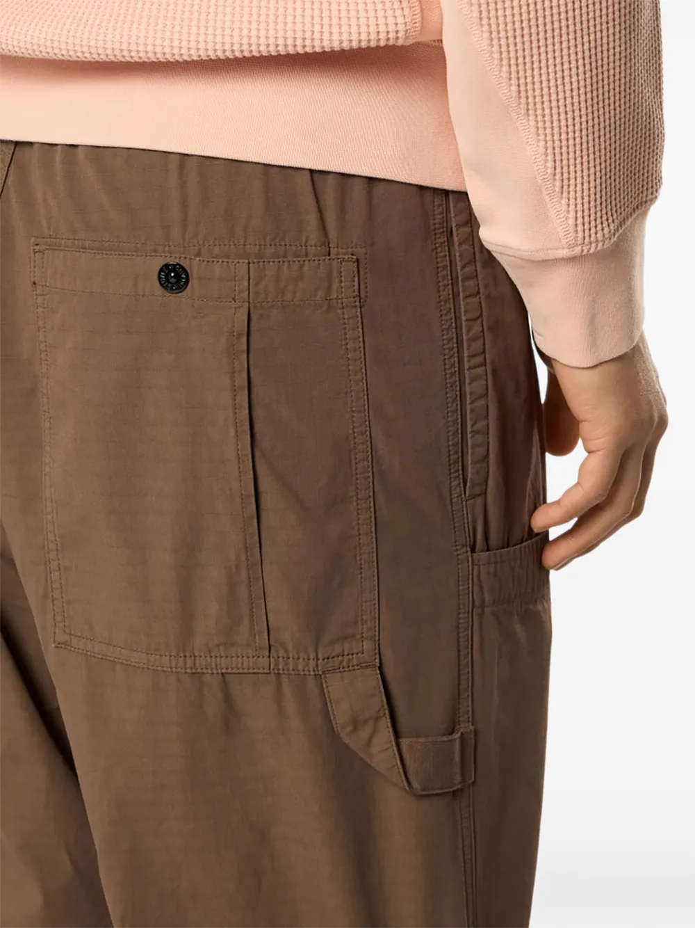 Close up of brown pants, showing texture of the cotton fabric