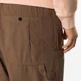 Close up of brown pants, showing texture of the cotton fabric