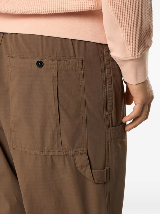 Close up of brown pants, showing texture of the cotton fabric