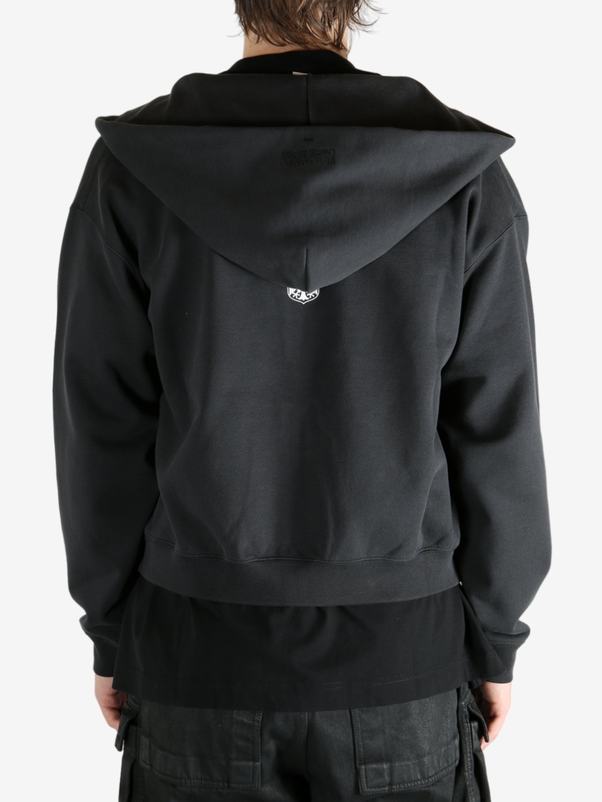 Black hoodie worn by a person, showing the hoodie's fit