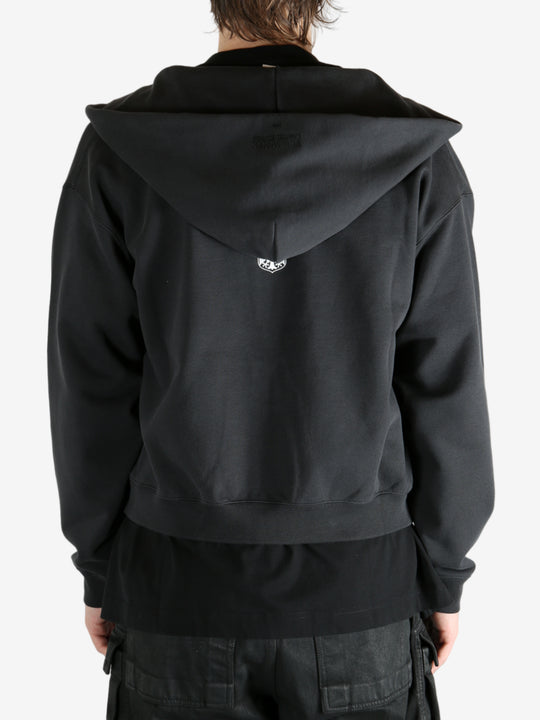 Black hoodie worn by a person, showing the hoodie's fit