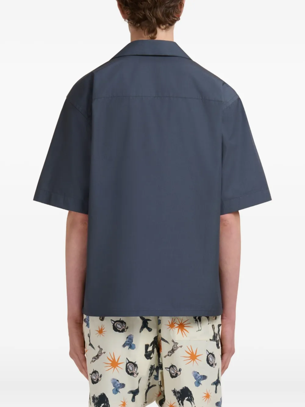 Blue shirt worn by a person, showing the shirt fit