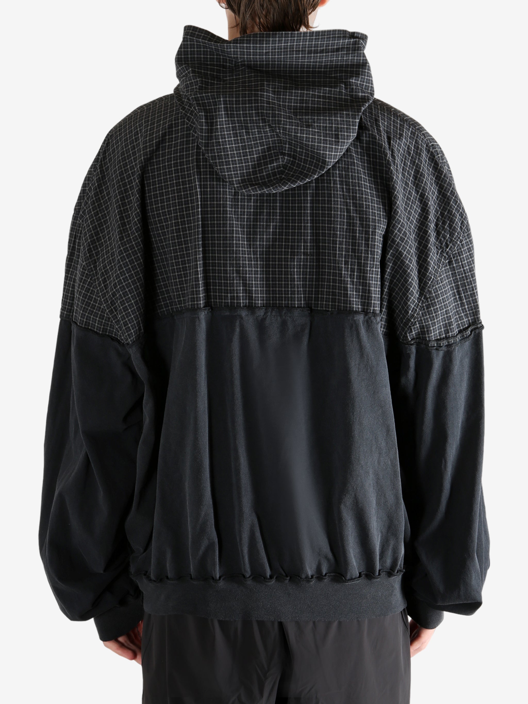 Black sweater worn by a person, showing the sweater's fit