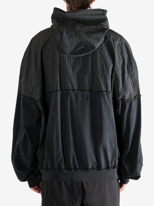 Black sweater worn by a person, showing the sweater's fit