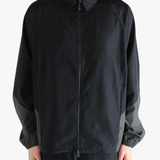 Black jacket worn by a person, showing the jacket's fit
