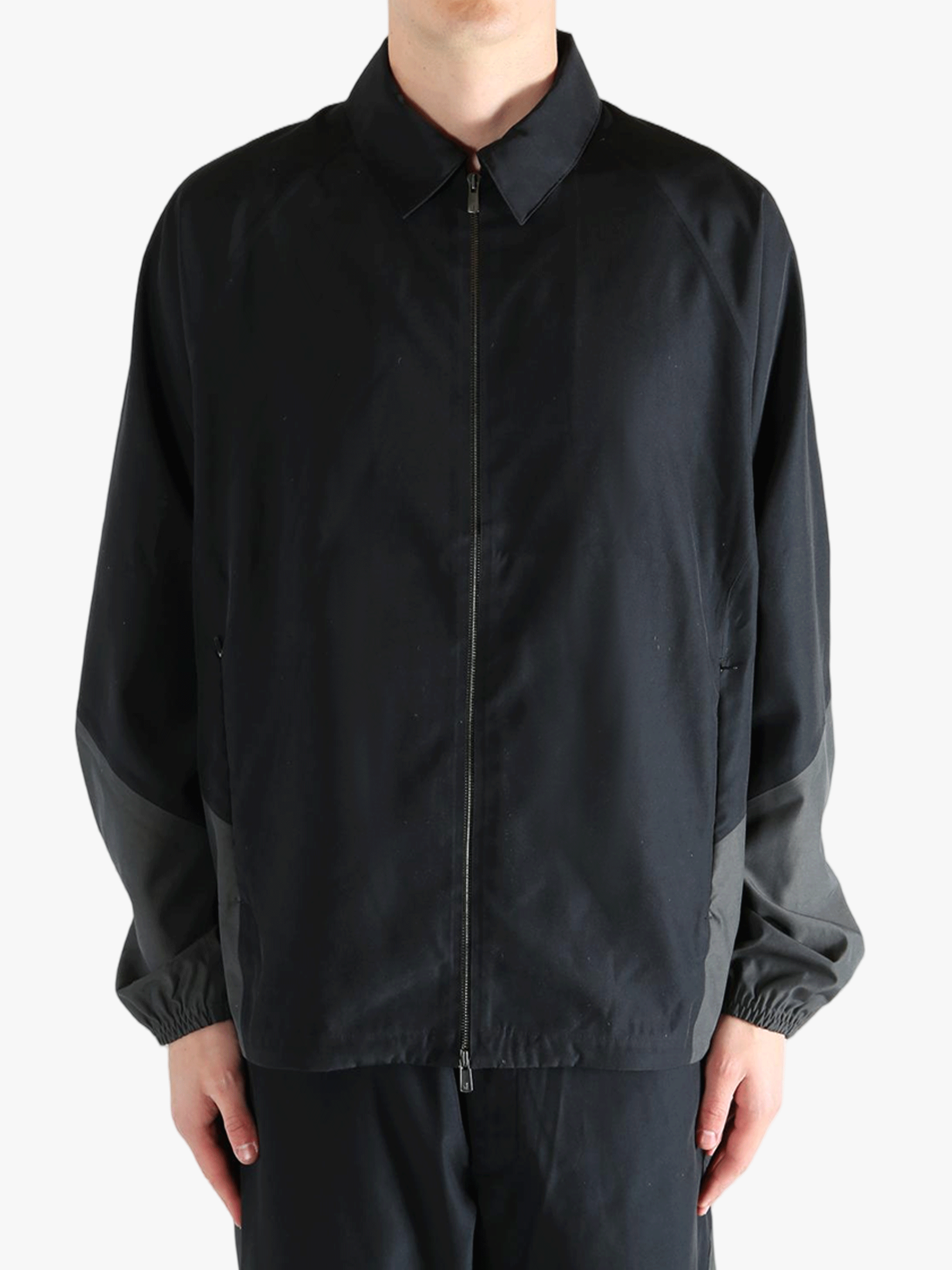 Black jacket worn by a person, showing the jacket's fit