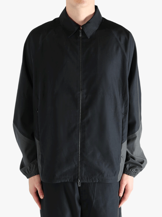 Black jacket worn by a person, showing the jacket's fit