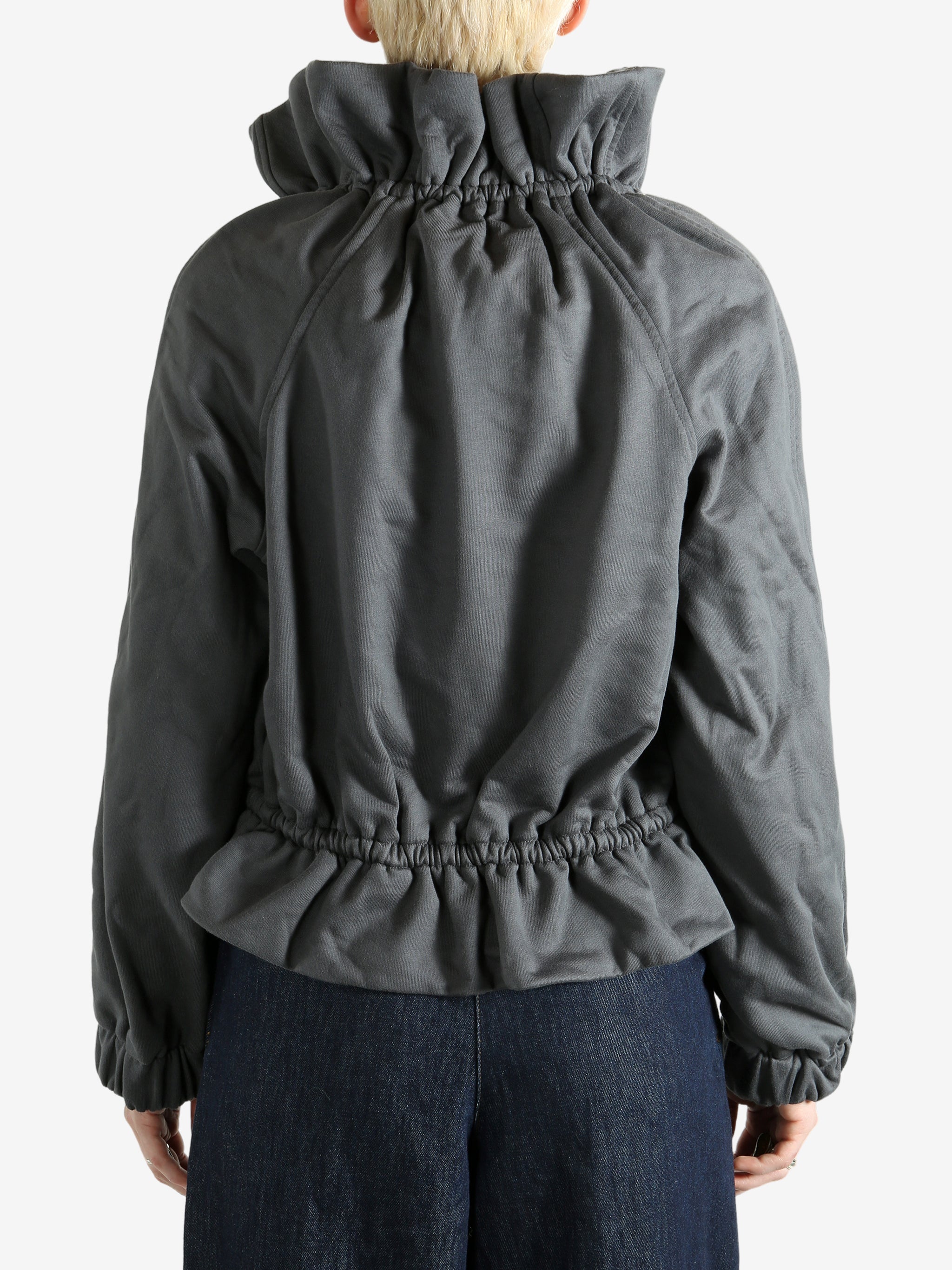 Grey jacket worn by a person, showing the jacket's fit