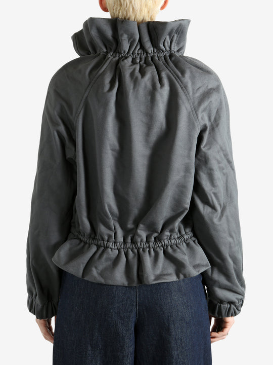 Grey jacket worn by a person, showing the jacket's fit