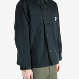 Black jacket worn by a person, showing the jacket's fit