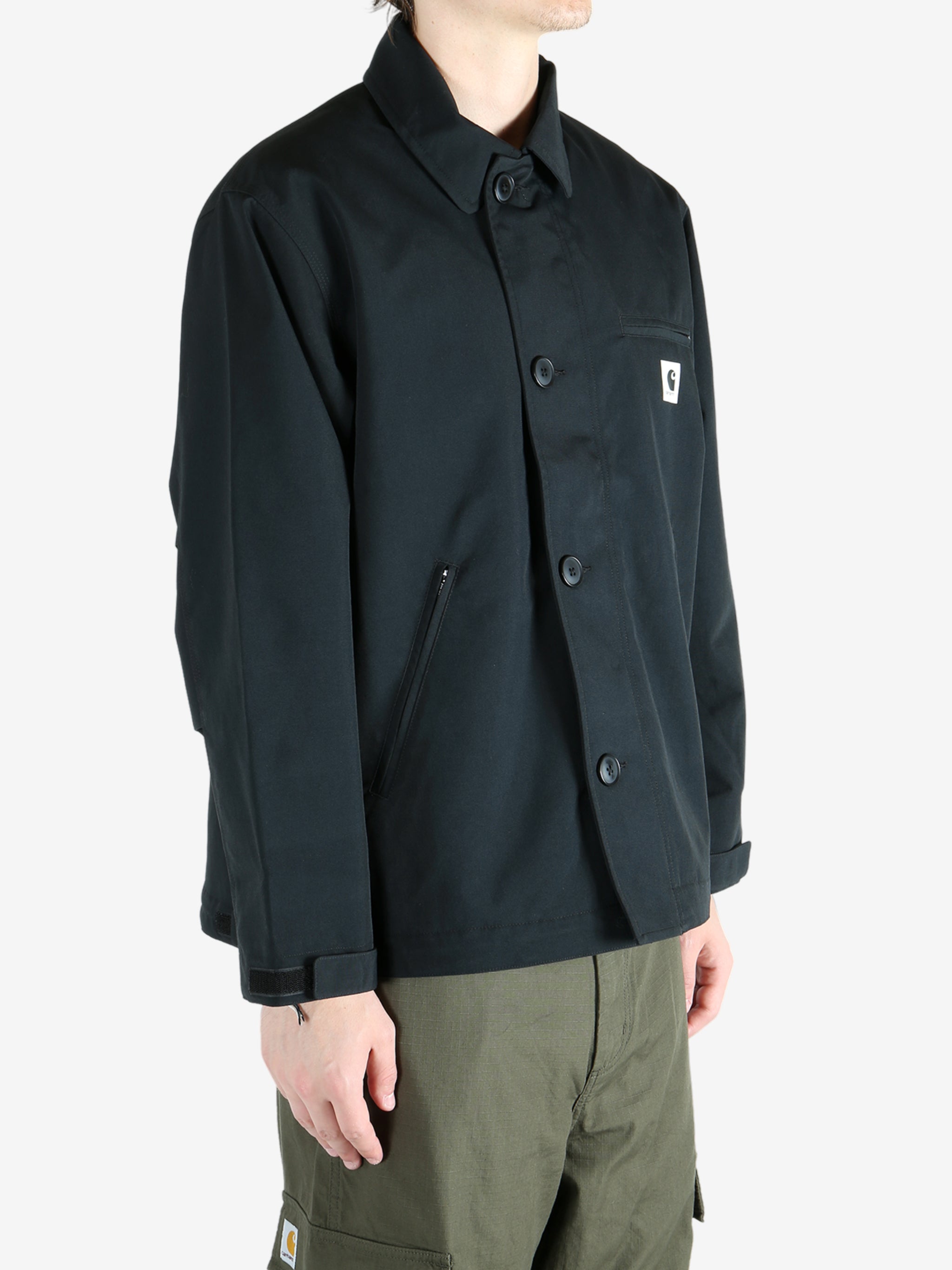 Black jacket worn by a person, showing the jacket's fit