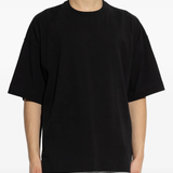 black t-shirts worn by a person, showing the t-shirts  fit