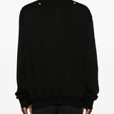 Black shirt worn by a person, showing the shirt's fit