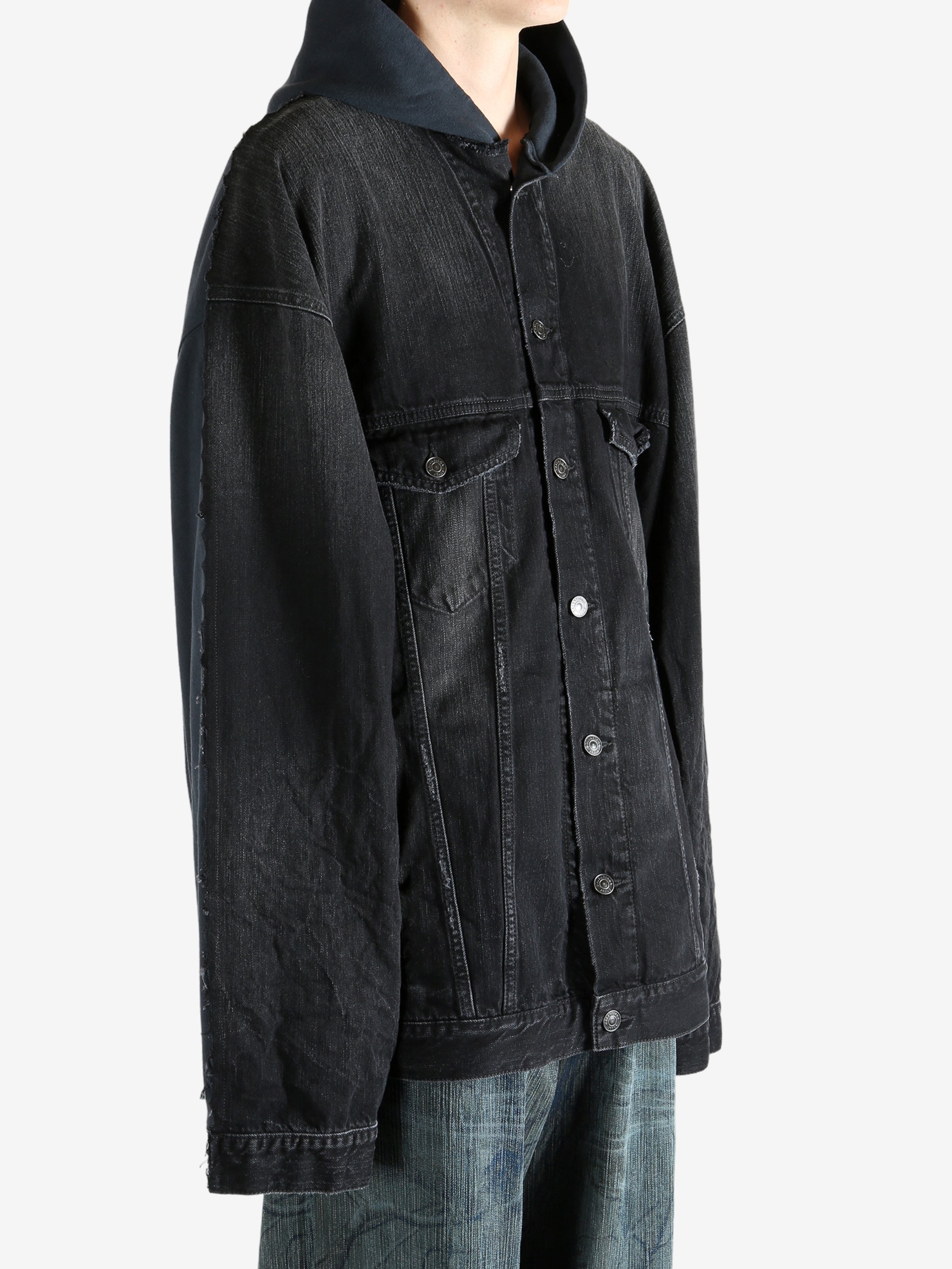 Black jacket worn by a person, showing the jacket fit